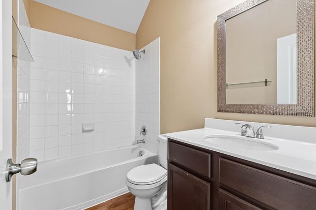 Full guest bath featuring shower/tub combination, vanity, and wood-style flooring | Image 27