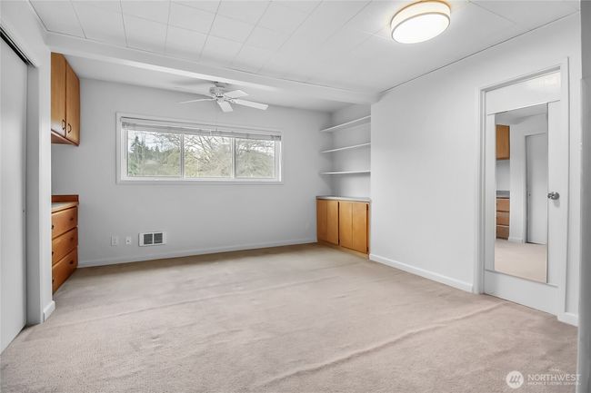 The second bedroom suite includes built-in shelving. | Image 17