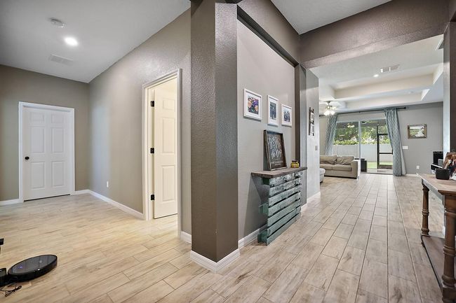Hallway leading to additional bedrooms, bathroom, and laundry room | Image 23