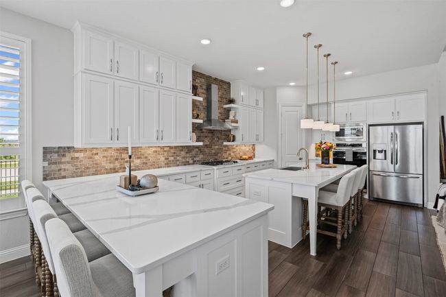 Kitchen with appliances with stainless steel finishes, plenty of natural light, a breakfast bar area, tasteful backsplash, and recessed lighting | Image 12