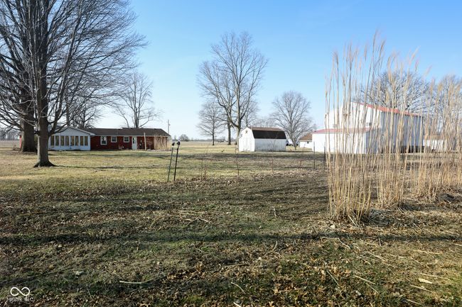view of yard featuring an outdoor structure, a pole building, and fence | Image 38