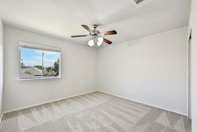 Carpeted empty room featuring a ceiling fan and baseboards | Image 17
