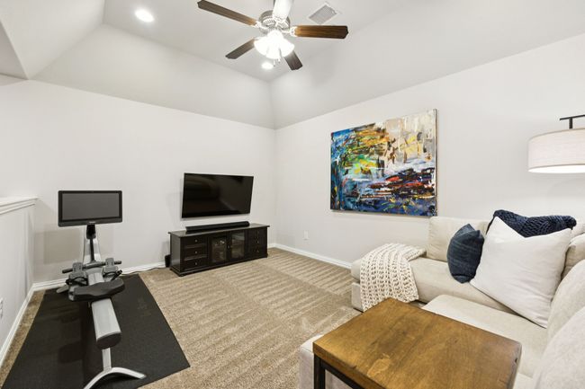 Living room with a ceiling fan, carpet flooring, vaulted ceiling, and recessed lighting | Image 16