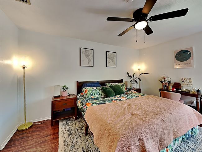 Bedroom with wood finished floors and ceiling fan | Image 9
