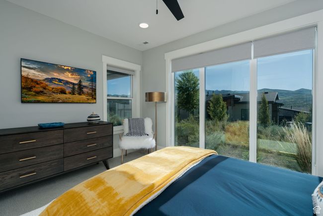 Carpeted bedroom with a ceiling fan and recessed lighting | Image 37