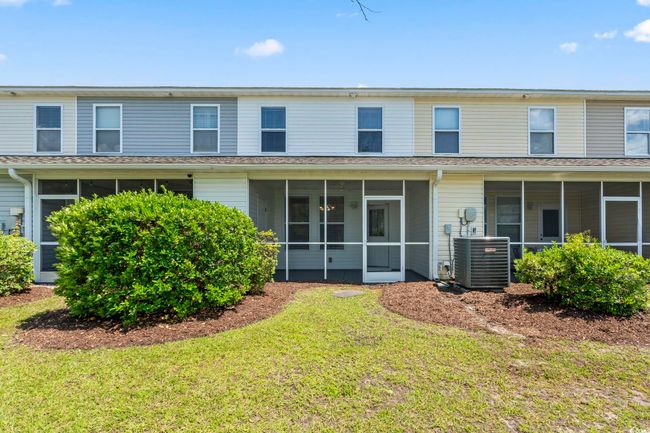 Back of house with a sunroom, central AC, and a yard | Image 25