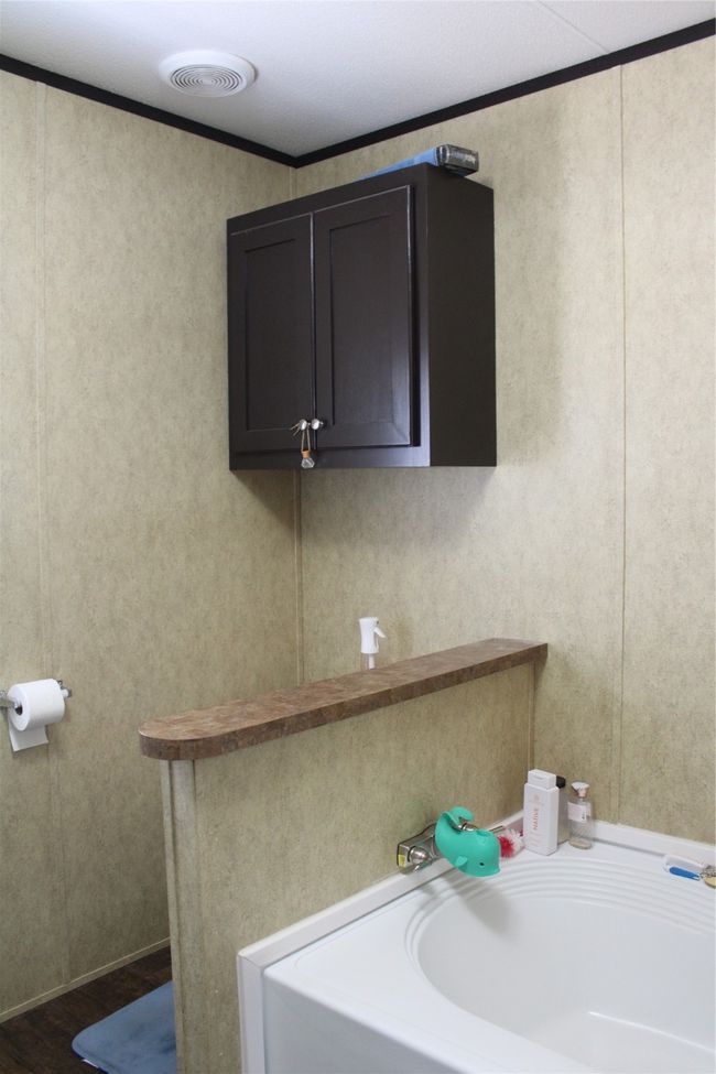 Bathroom featuring a bath, wood finished floors, and crown molding | Image 26