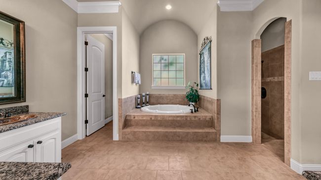 Full bathroom featuring a garden tub, ornamental molding, vanity, baseboards, and a walk in shower | Image 24