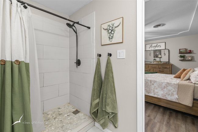Full bathroom with connected bathroom, wood finished floors, and a tile shower | Image 18