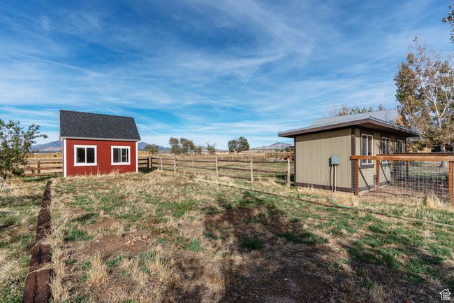View of yard with a rural view and a shed | Image 50