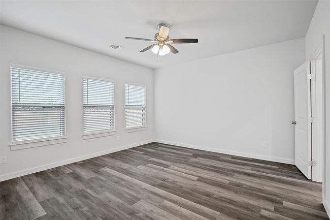 Unfurnished room featuring ceiling fan and dark wood-style flooring | Image 8
