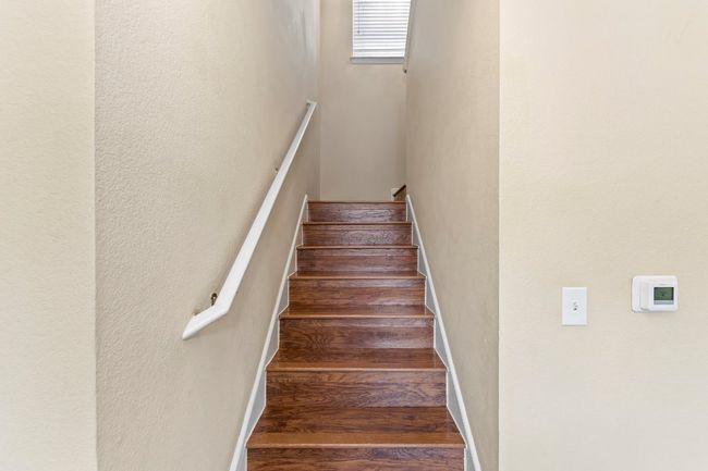 Stairway featuring wood finished floors | Image 23