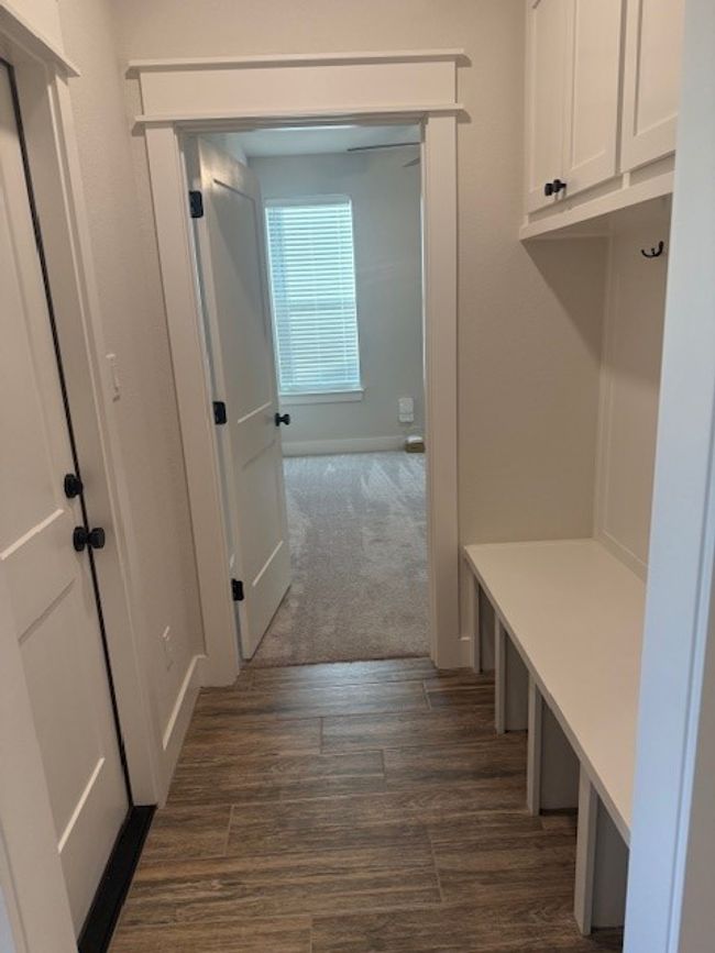 Mudroom featuring dark wood-type flooring and baseboards | Image 19