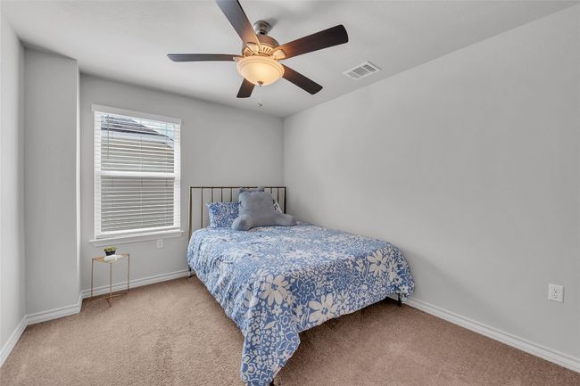 Bedroom featuring carpet floors, baseboards, and a ceiling fan | Image 19