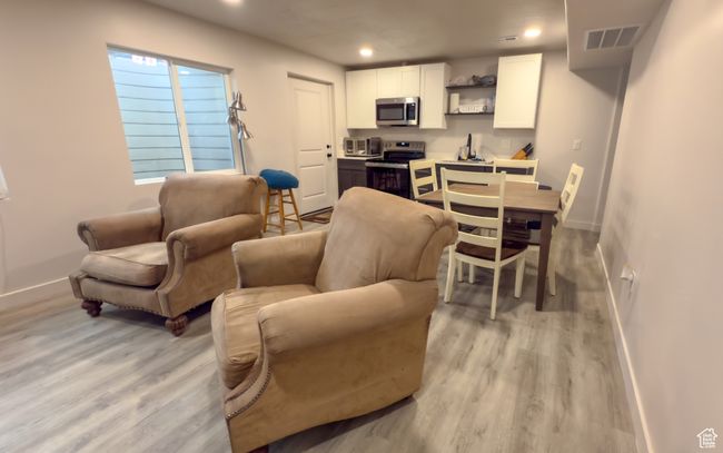 Living room with light wood finished floors and recessed lighting | Image 19
