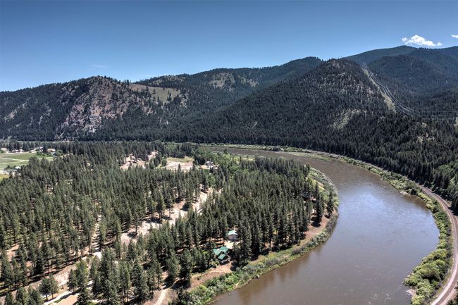 View of mountain backdrop featuring a heavily wooded area and a large body of water | Image 71