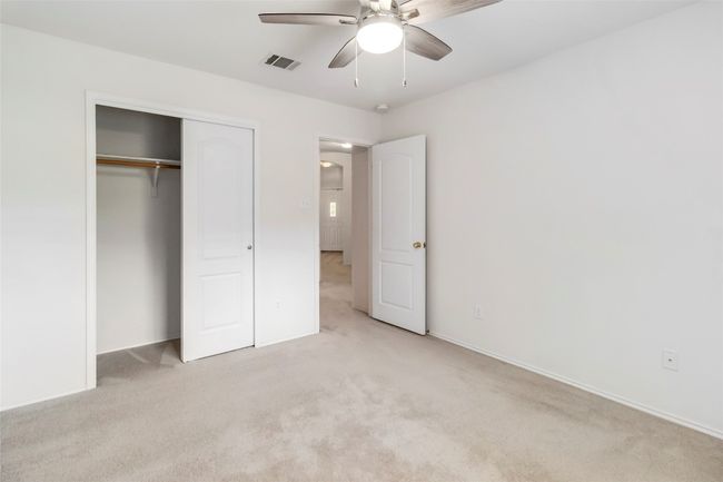 Unfurnished bedroom featuring light colored carpet, a closet, and baseboards | Image 30