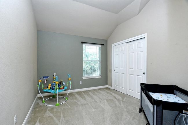 Playroom featuring carpet, lofted ceiling, and baseboards | Image 26
