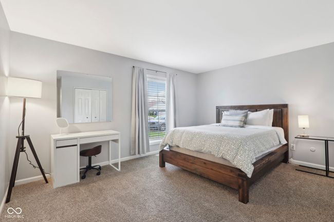 bedroom featuring baseboards and light colored carpet | Image 14