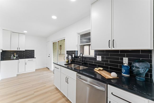 Kitchen featuring dishwasher, backsplash, white cabinets, recessed lighting, and light wood-style floors | Image 9
