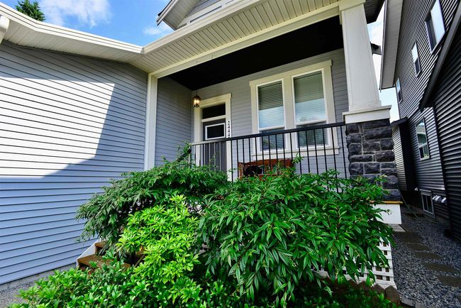 Doorway to property featuring stone siding and covered porch | Image 35