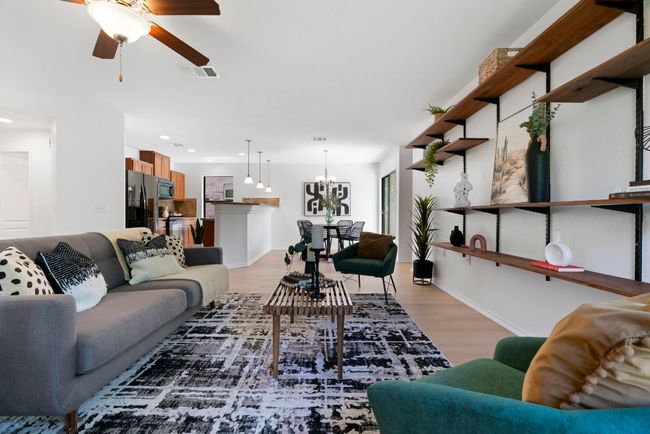 Light oak wood-look LVP flooring and black-framed windows run throughout the home, creating a seamless and inviting atmosphere. | Image 6