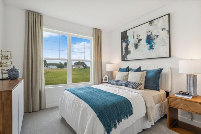 Photo is of the actual model. The main level bedroom. | Image 10