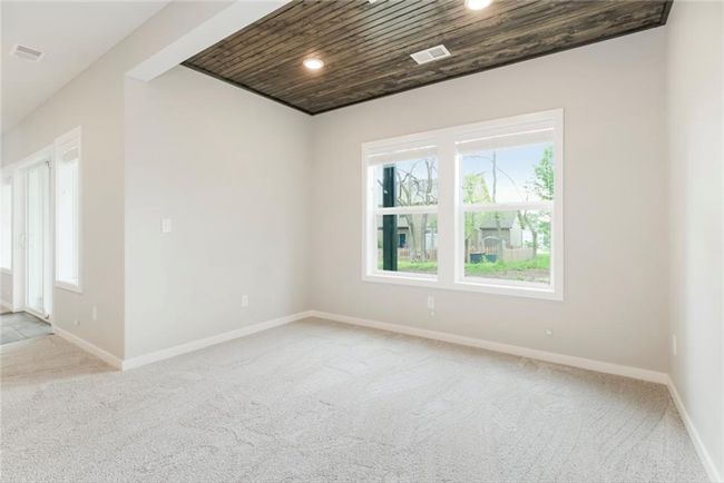 Spare room with wooden ceiling, light colored carpet, plenty of natural light, baseboards, and recessed lighting | Image 16
