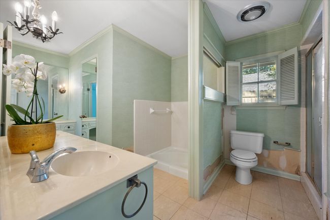 Bathroom with vanity, a stall shower, a chandelier, crown molding, and tile patterned floors | Image 25