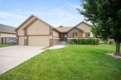 View of front of home with a garage and a front lawn | Image 1