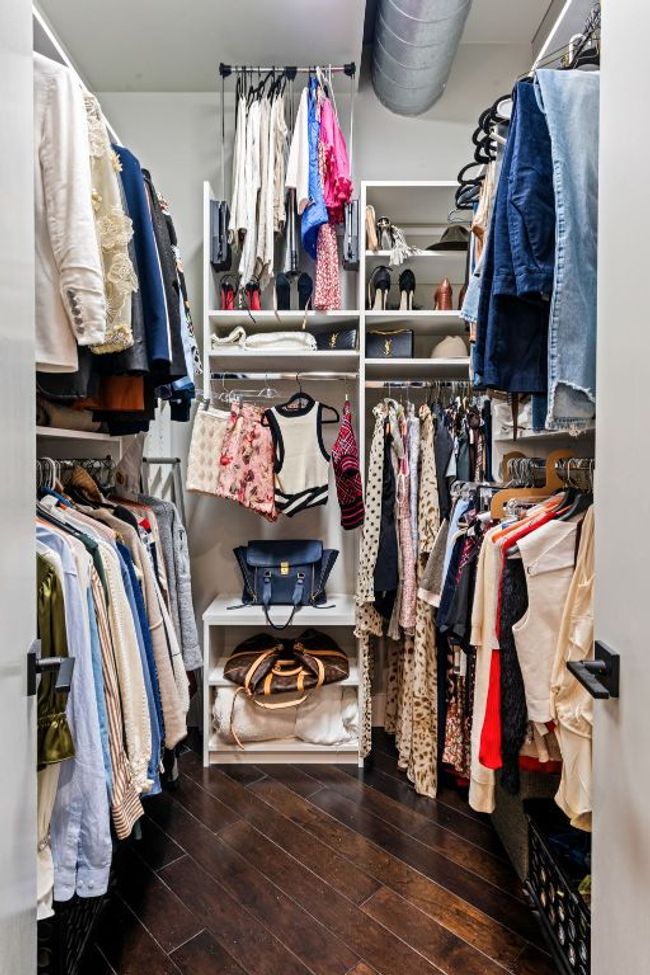 Walk in closet featuring dark wood-flooring | Image 29