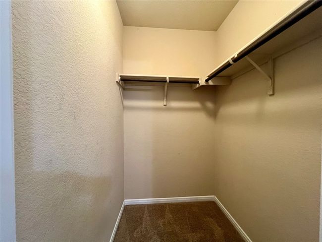 Spacious bedroom closet with carpet | Image 11