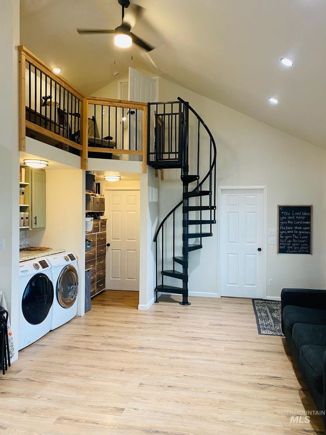 Laundry room featuring washer and dryer, ceiling fan, light wood-style flooring, a high ceiling, and recessed lighting | Image 20