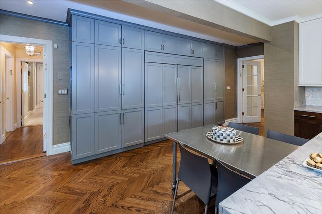 Kitchen with ornamental molding and light stone countertops | Image 7
