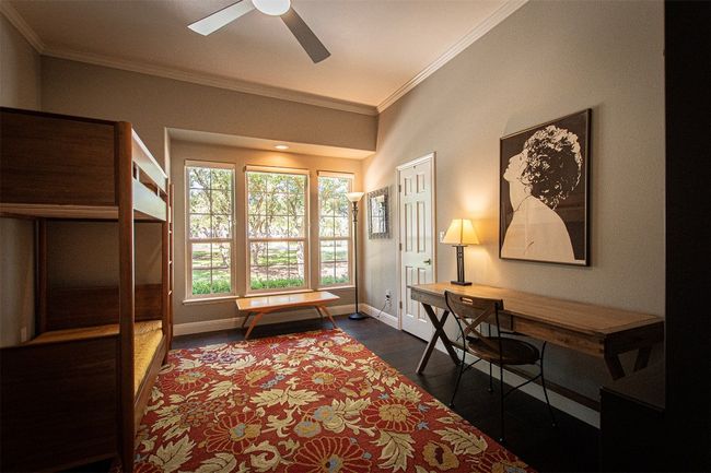 Office with ornamental molding, baseboards, ceiling fan, and dark wood-style floors | Image 24