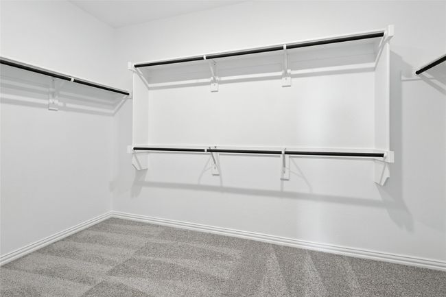 Spacious closet with carpet floors | Image 21
