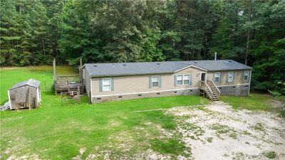 Rear view of house with a lawn | Image 2