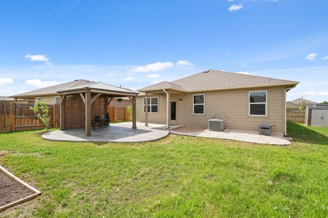 Rear view of property featuring a gazebo. | Image 23
