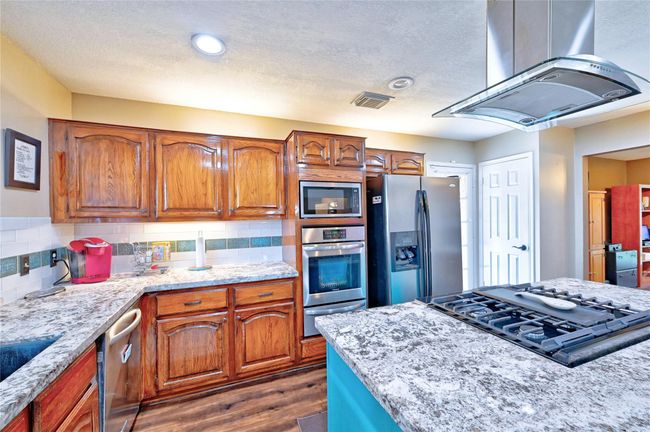 Elegant cabinet lighting enhances both the top and bottom, creating a warm and inviting kitchen ambiance. | Image 13