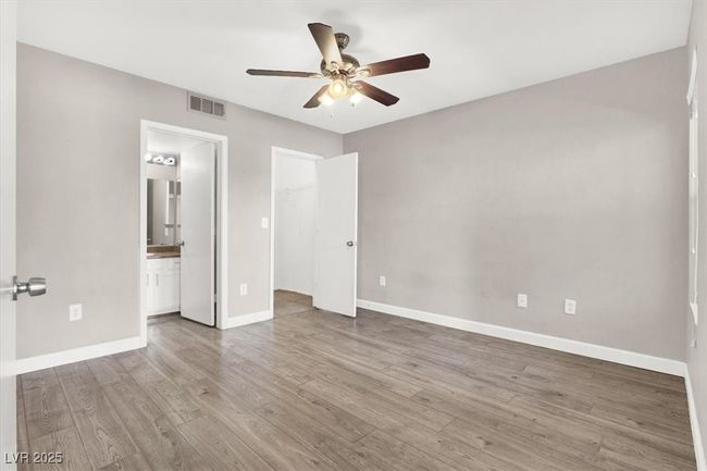 Unfurnished bedroom featuring wood finished floors, visible vents, and baseboards | Image 14