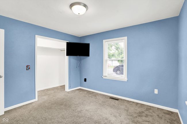 unfurnished bedroom with carpet flooring, a closet, and baseboards | Image 18