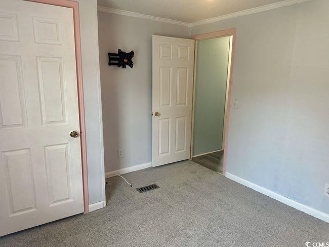 Unfurnished bedroom featuring carpet, baseboards, and ornamental molding | Image 21