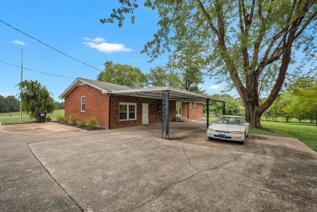 SINGLE CARPORT WITH ADJOINING COVERED PATIO. LOTS OF EXTRA PARKING. PERFECT SPACE FOR 2 CAR GARAGE OR MORE IF YOU DESIRE. | Image 6