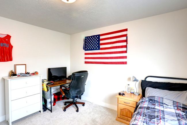 Bedroom featuring light colored carpet and baseboards | Image 18