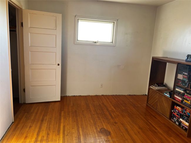 Unfurnished bedroom with hardwood / wood-style flooring | Image 60