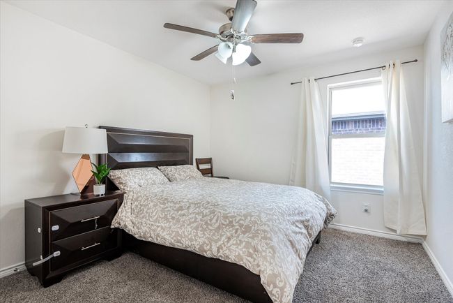 Bedroom with carpet floors, a ceiling fan, and baseboards | Image 27