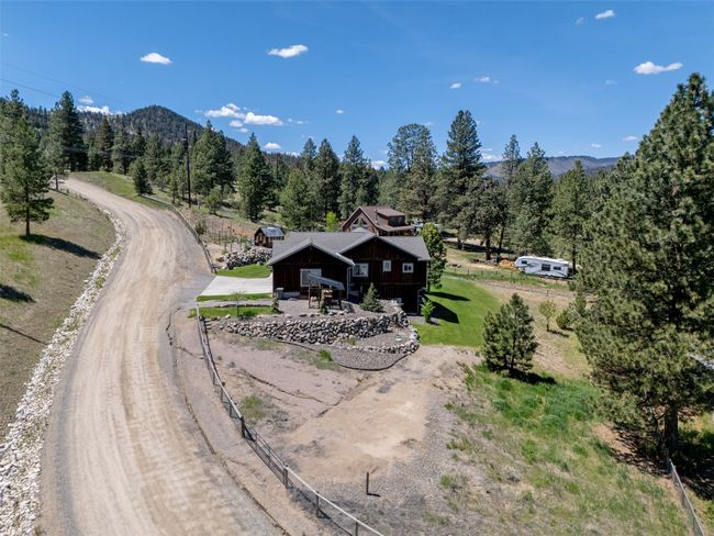 Aerial view of property and surrounding area with a forest and a mountainous background | Image 58