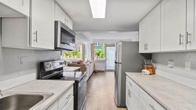 view from kitchen to back balcony door | Image 10