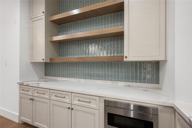 Wooden shelves provided for additional storage and create an open, are feel, enhancing space with both function and style. | Image 18