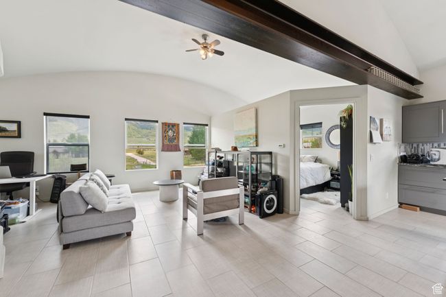 Living room featuring vaulted ceiling, a desk, and ceiling fan | Image 32